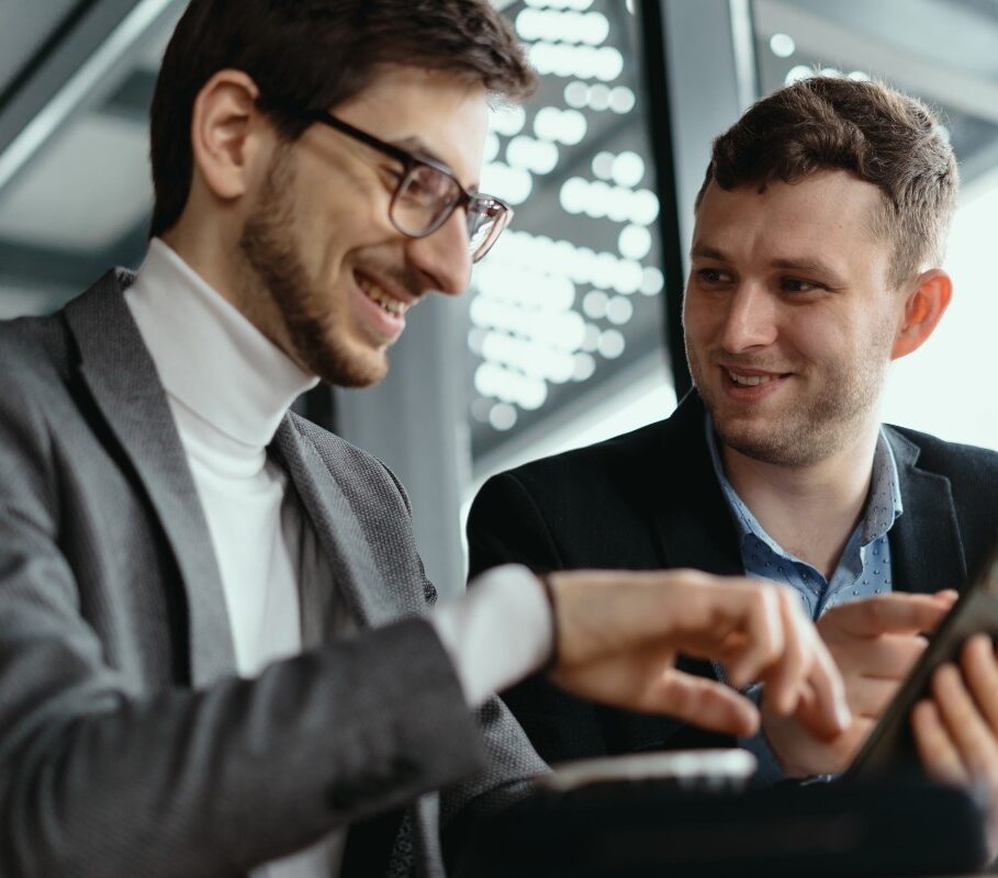 two-businessmen-having-a-conversation-using-a-smar-2021-04-04-14-42-28-utc-e1627956598117.jpg