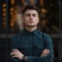 young-man-close-up-portrait-with-lights-in-backgro-2021-04-05-16-12-22-utc-e1627920496460.jpg